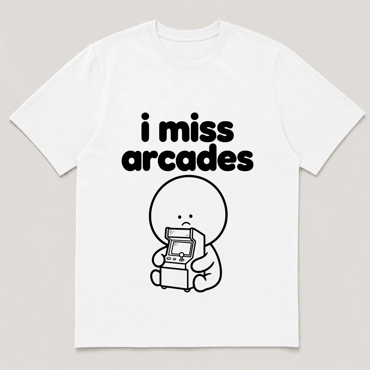 lonely boi tee: a small sad cartoon boy hugging a glowing arcade cabinet with a joystick, with the words i miss arcades above him, White front view