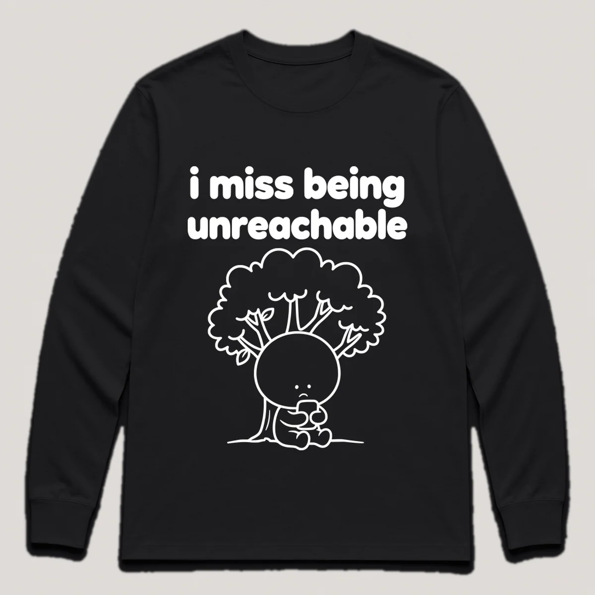 lonely boi tee: a small sad cartoon boy hugging a phone with no signal bars under a tree, with the words i miss being unreachable above him, Black front view