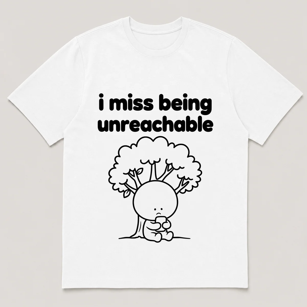 lonely boi tee: a small sad cartoon boy hugging a phone with no signal bars under a tree, with the words i miss being unreachable above him, White front view