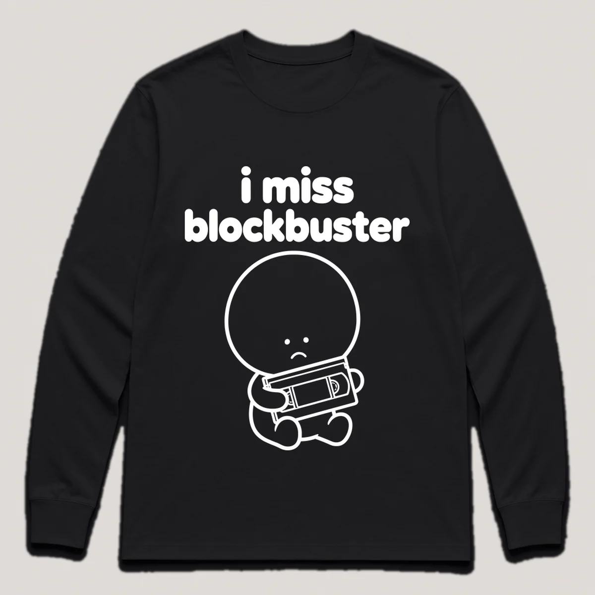lonely boi tee: a small sad cartoon boy hugging a vhs tape in a rental case, with the words i miss blockbuster above him, Black front view