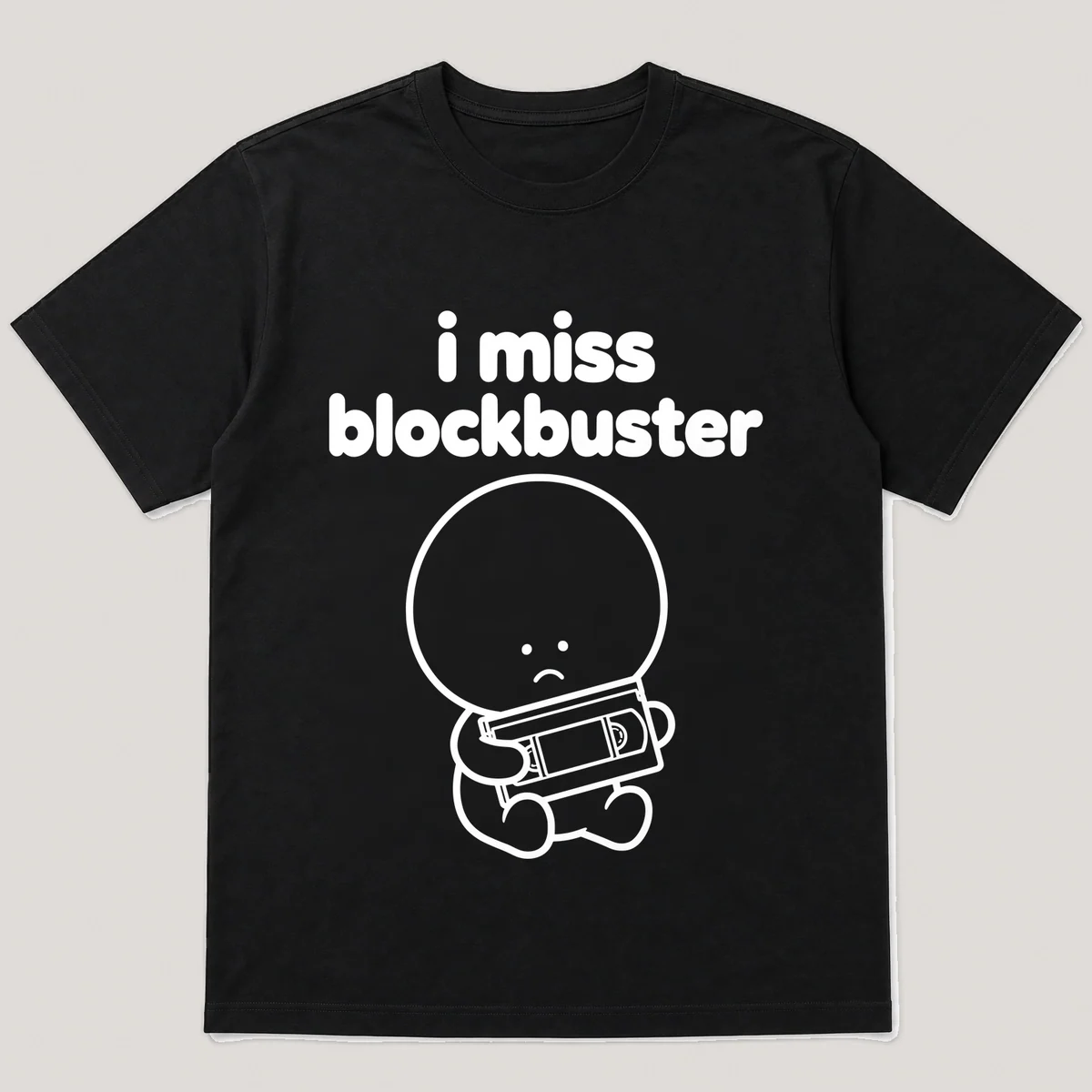 lonely boi tee: a small sad cartoon boy hugging a vhs tape in a rental case, with the words i miss blockbuster above him, Black front view