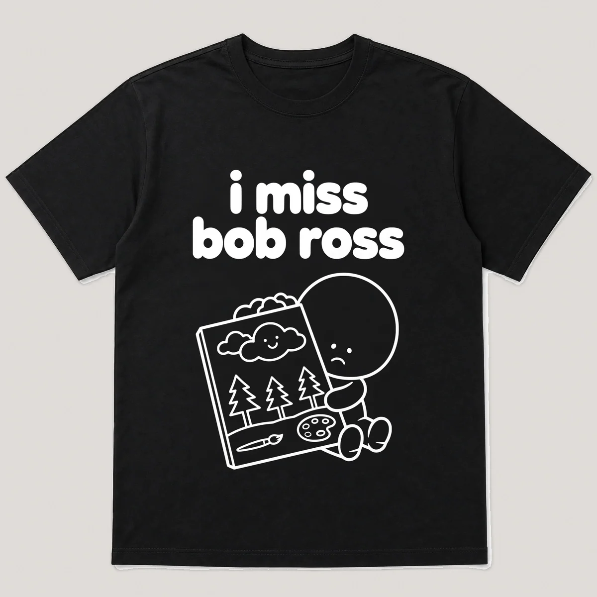 lonely boi tee: a small sad cartoon boy hugging a small canvas with a happy cloud, with the words i miss bob ross above him, Black front view