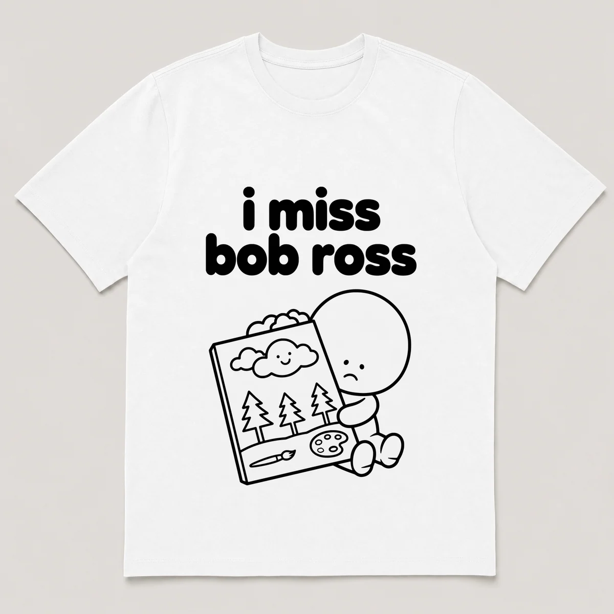 lonely boi tee: a small sad cartoon boy hugging a small canvas with a happy cloud, with the words i miss bob ross above him, White front view