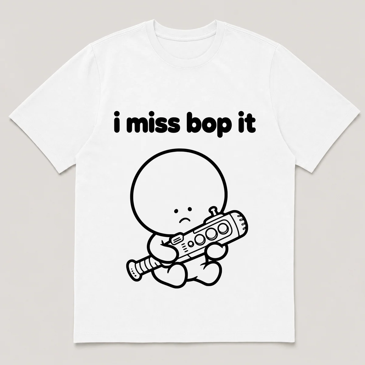 lonely boi tee: a small sad cartoon boy hugging a chunky plastic game baton with buttons, with the words i miss bop it above him, White front view