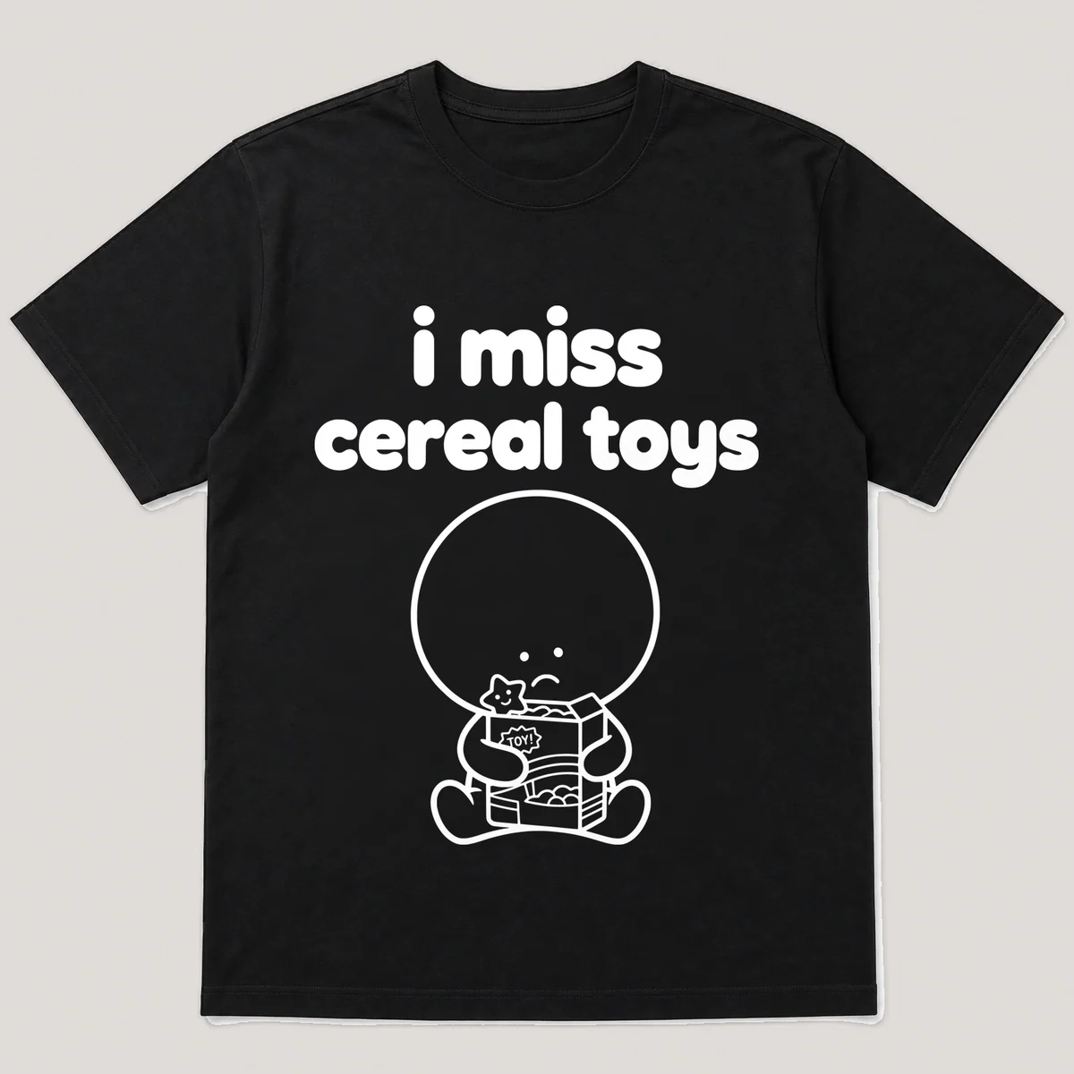 lonely boi tee: a small sad cartoon boy hugging a cereal box with a toy surprise, with the words i miss cereal toys above him, Black front view
