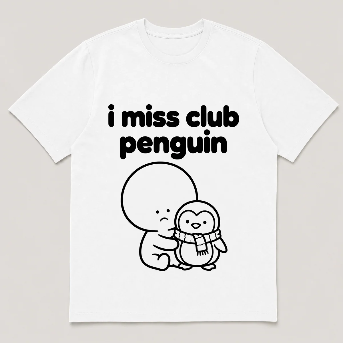 lonely boi tee: a small sad cartoon boy hugging a small cartoon penguin with a scarf, with the words i miss club penguin above him, White front view