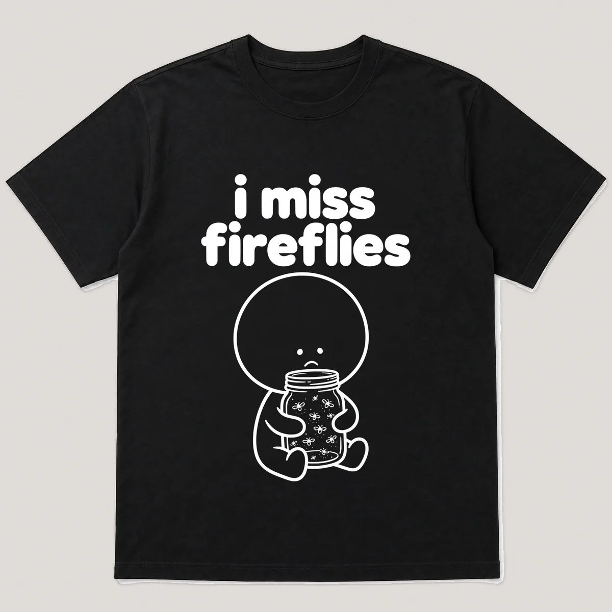 lonely boi tee: a small sad cartoon boy hugging a mason jar of glowing fireflies, with the words i miss fireflies above him, Black front view