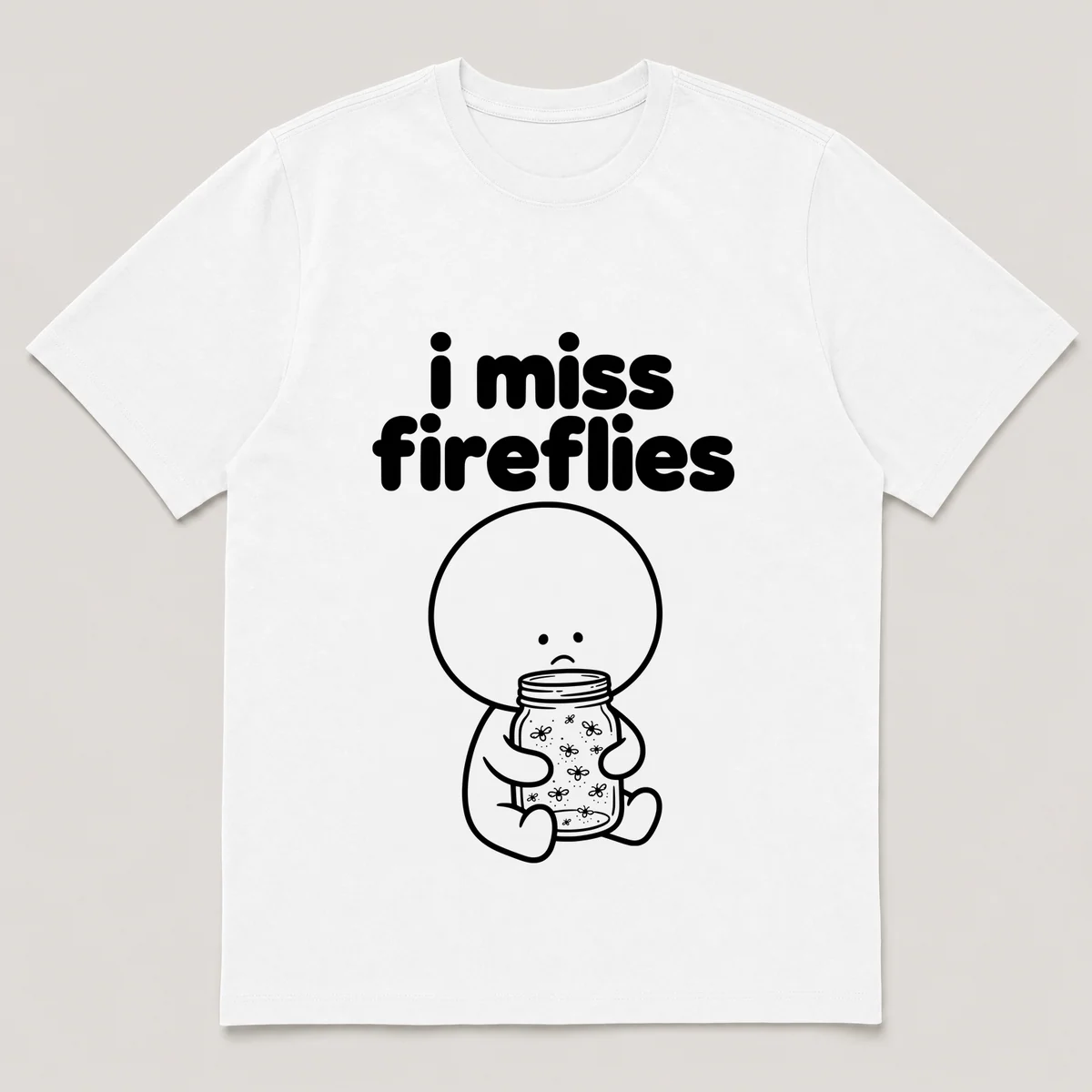 lonely boi tee: a small sad cartoon boy hugging a mason jar of glowing fireflies, with the words i miss fireflies above him, White front view