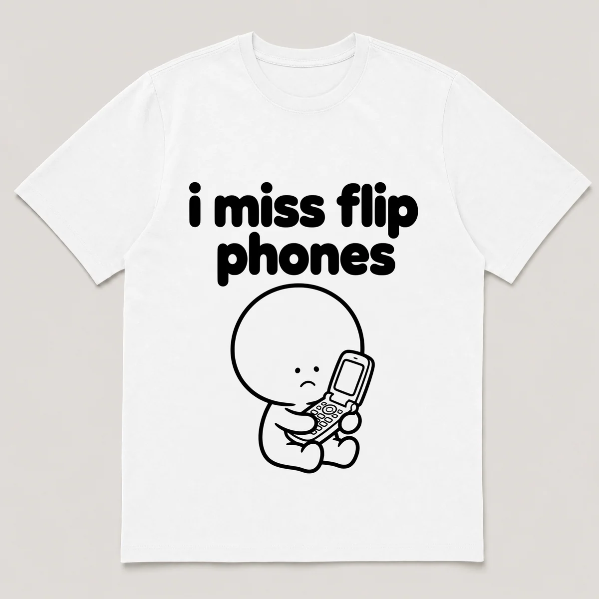 lonely boi tee: a small sad cartoon boy hugging an open flip phone, with the words i miss flip phones above him, White front view
