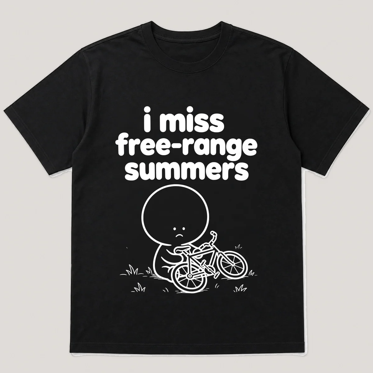 lonely boi tee: a small sad cartoon boy hugging a bike dropped sideways on the grass, with the words i miss free-range summers above him, Black front view