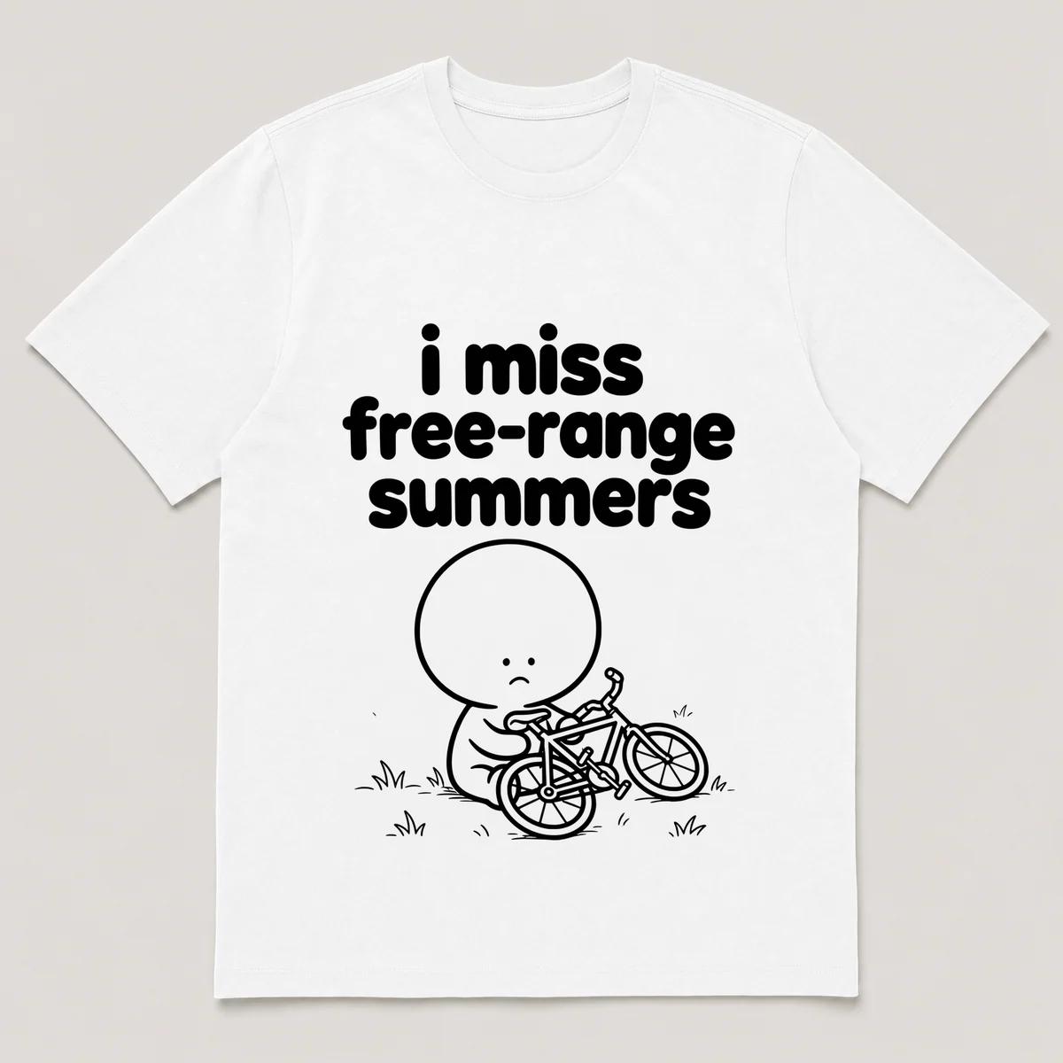 lonely boi tee: a small sad cartoon boy hugging a bike dropped sideways on the grass, with the words i miss free-range summers above him, White front view