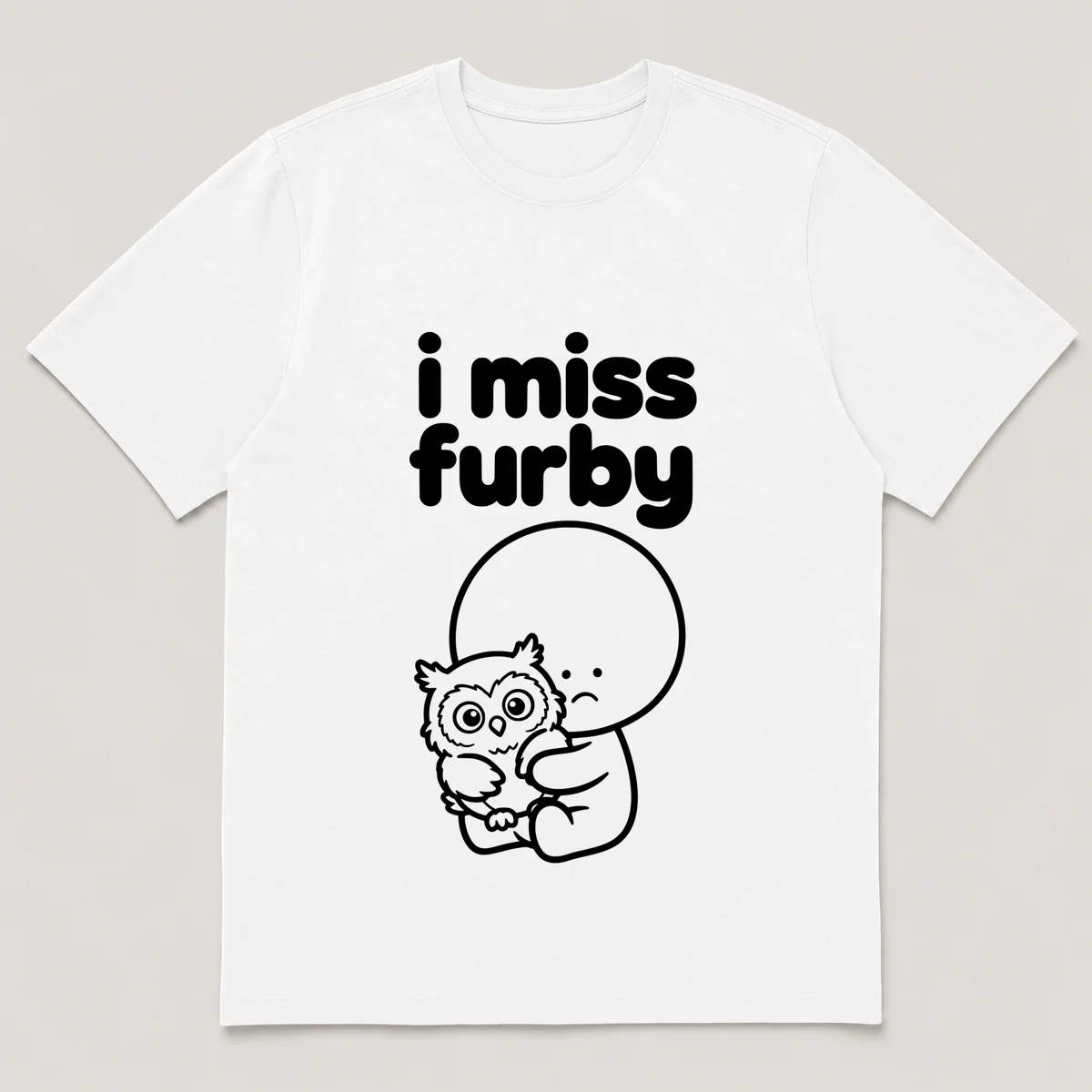 lonely boi tee: a small sad cartoon boy hugging a wide-eyed furry owl-like toy, with the words i miss furby above him, White front view