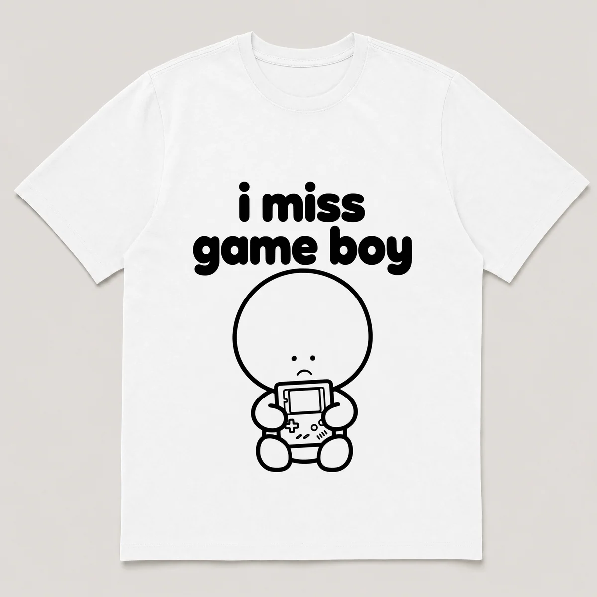 lonely boi tee: a small sad cartoon boy hugging a chunky handheld game console, with the words i miss game boy above him, White front view