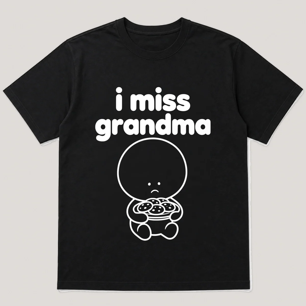 lonely boi tee: a small sad cartoon boy hugging a plate of warm cookies, with the words i miss grandma above him, Black front view