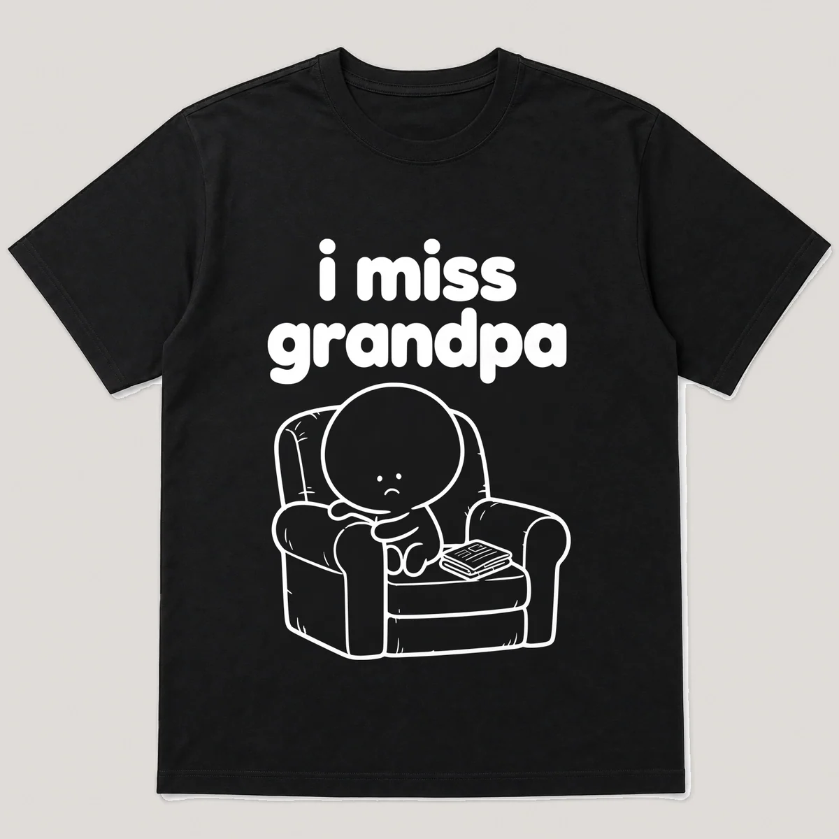 lonely boi tee: a small sad cartoon boy hugging a worn armchair with a folded newspaper, with the words i miss grandpa above him, Black front view