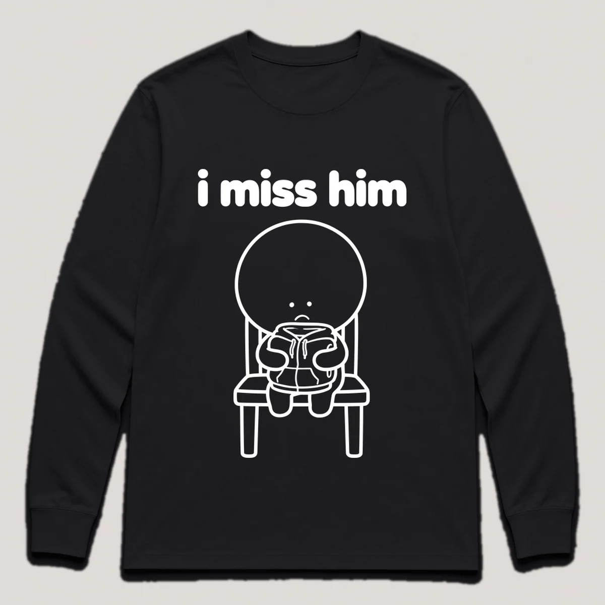 lonely boi tee: a small sad cartoon boy hugging a folded hoodie left on a chair, with the words i miss him above him, Black front view