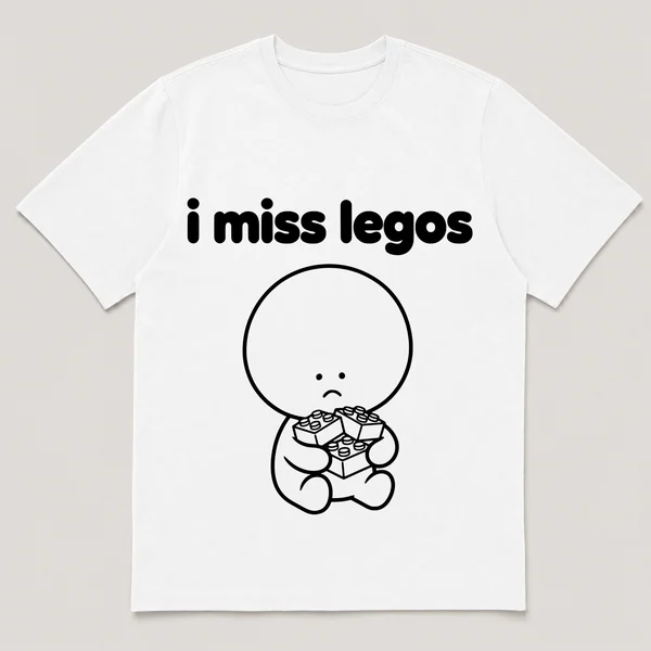 lonely boi tee: a small sad cartoon boy hugging a pile of small colorful building bricks, with the words i miss legos above him