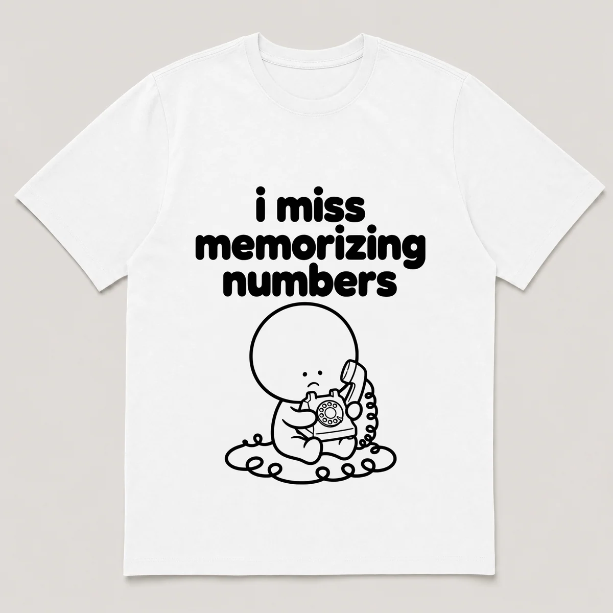 lonely boi tee: a small sad cartoon boy hugging a rotary phone with a long cord, with the words i miss memorizing numbers above him, White front view