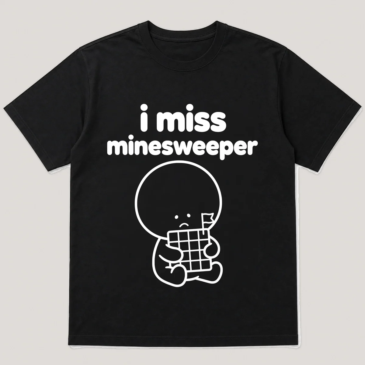 lonely boi tee: a small sad cartoon boy hugging a grid of gray tiles with a flag, with the words i miss minesweeper above him, Black front view
