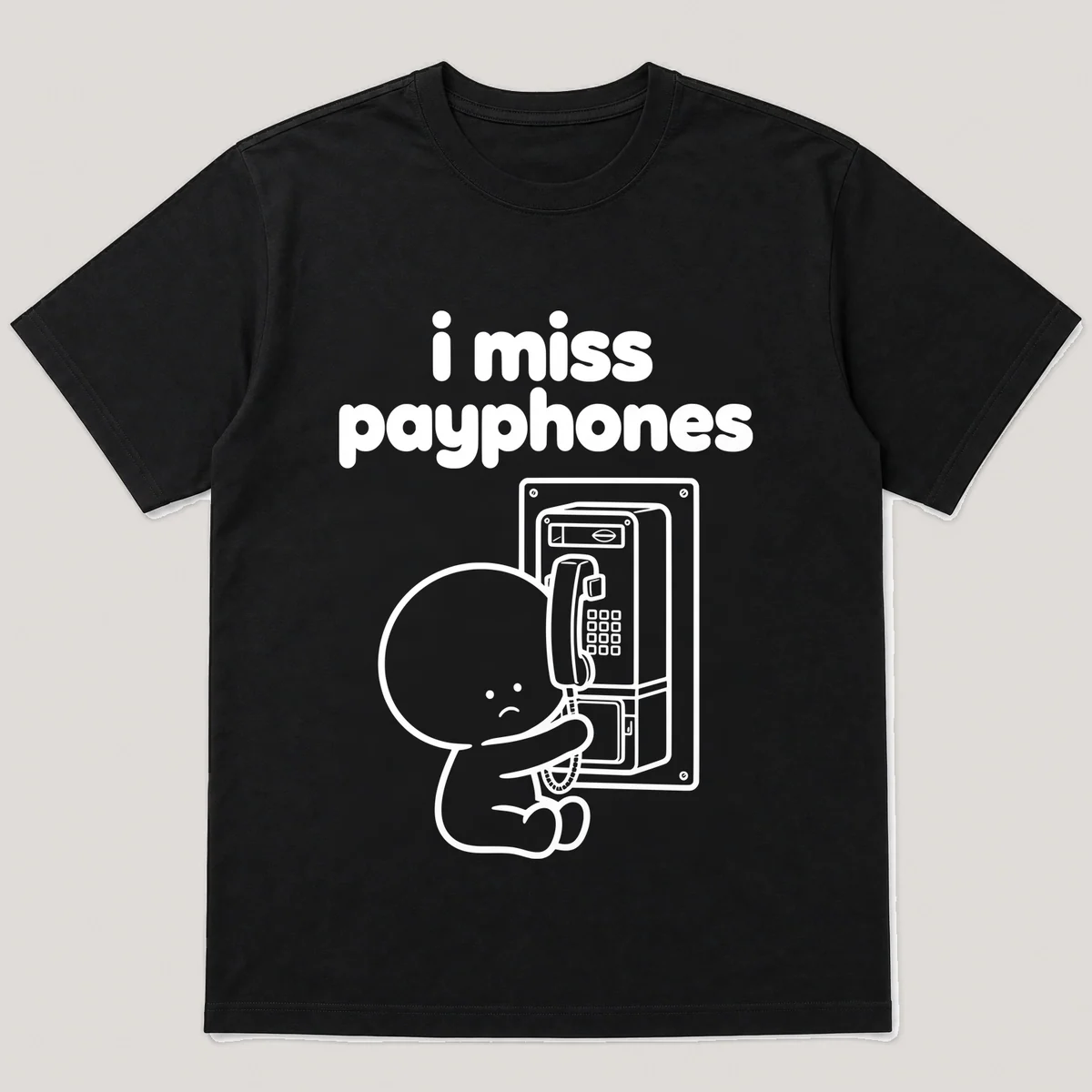 lonely boi tee: a small sad cartoon boy hugging a coin-operated payphone on a wall, with the words i miss payphones above him, Black front view
