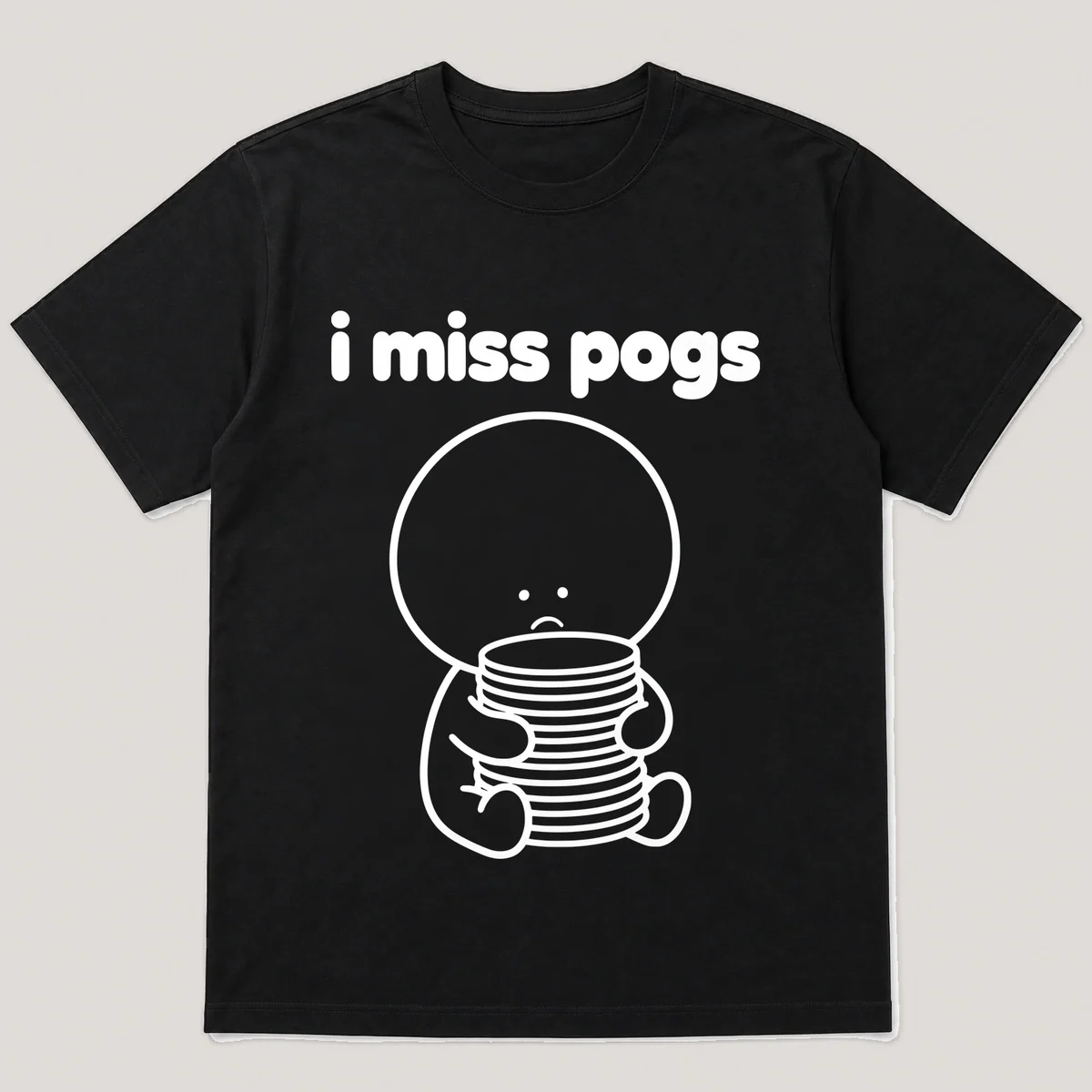 lonely boi tee: a small sad cartoon boy hugging a tall stack of round cardboard discs, with the words i miss pogs above him, Black front view