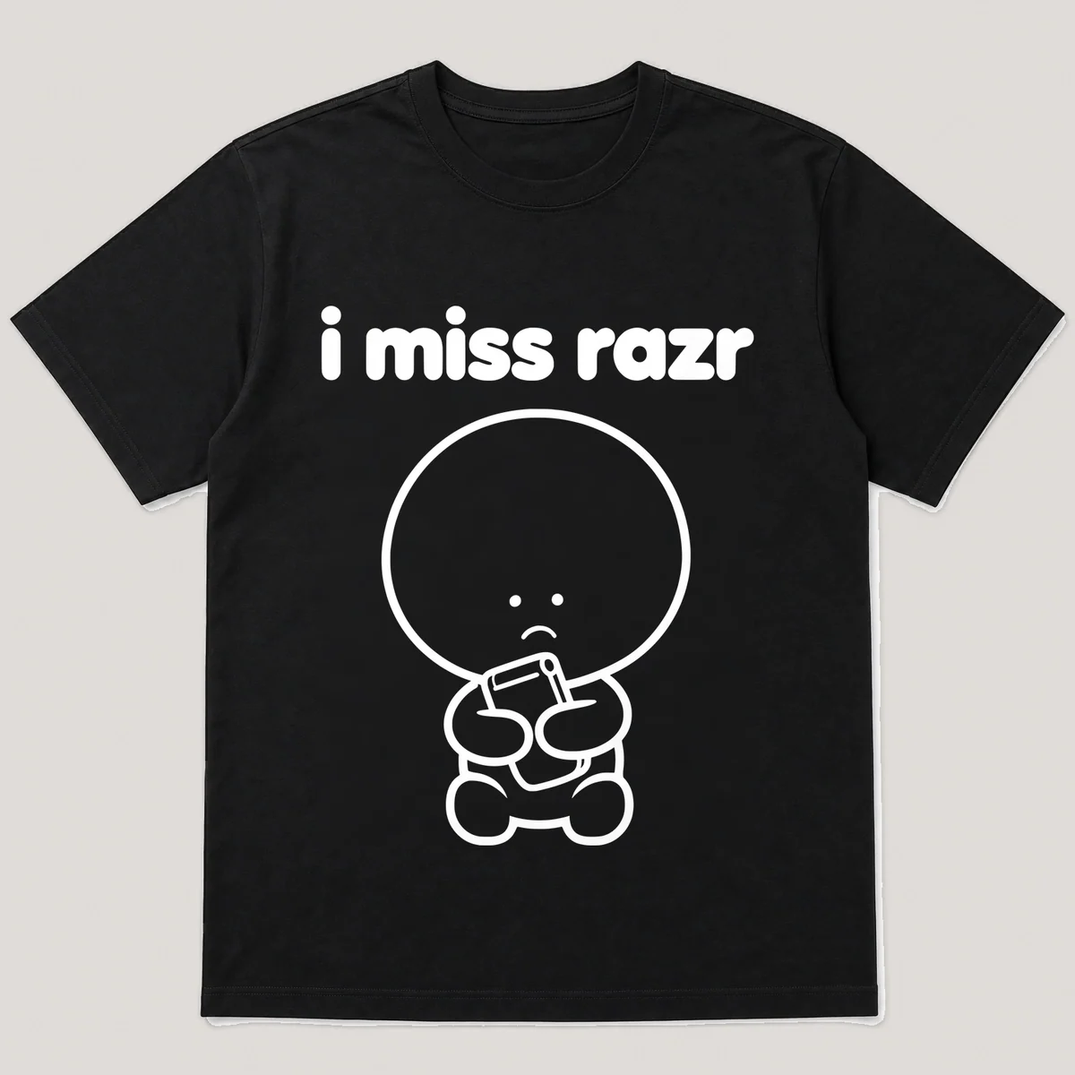lonely boi tee: a small sad cartoon boy hugging a thin flip phone snapping shut, with the words i miss razr above him, Black front view
