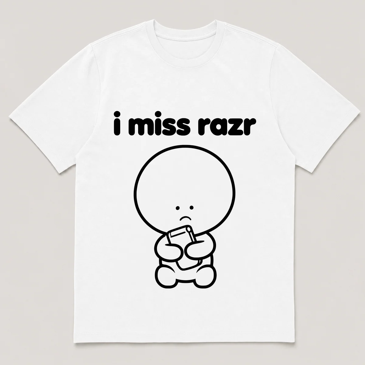 lonely boi tee: a small sad cartoon boy hugging a thin flip phone snapping shut, with the words i miss razr above him, White front view