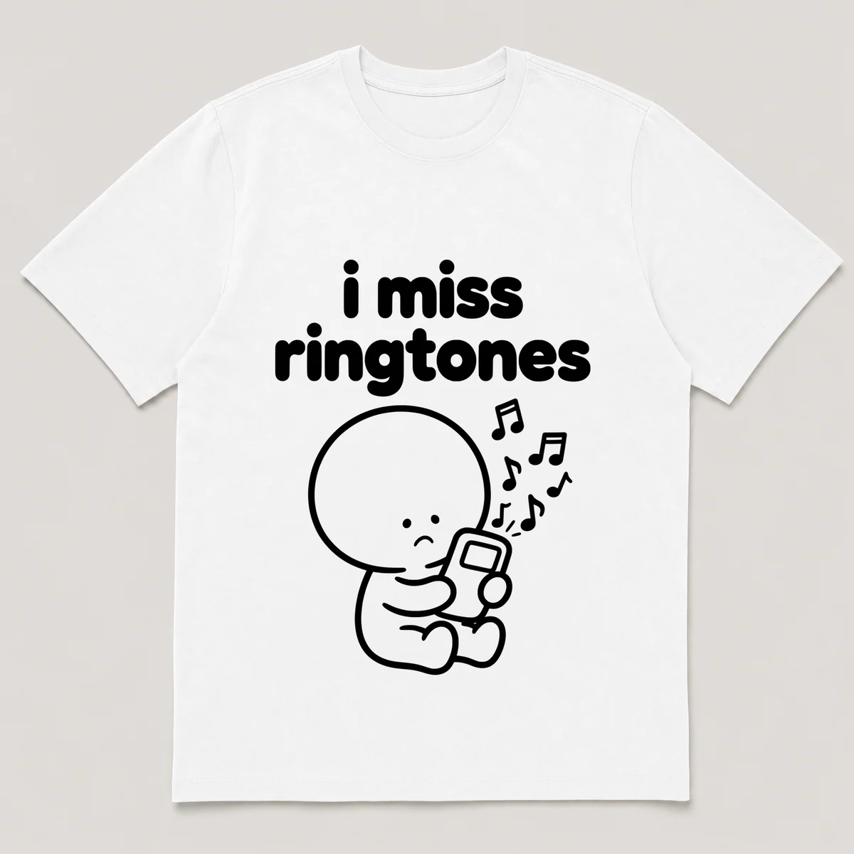 lonely boi tee: a small sad cartoon boy hugging a phone blasting chunky music notes, with the words i miss ringtones above him, White front view
