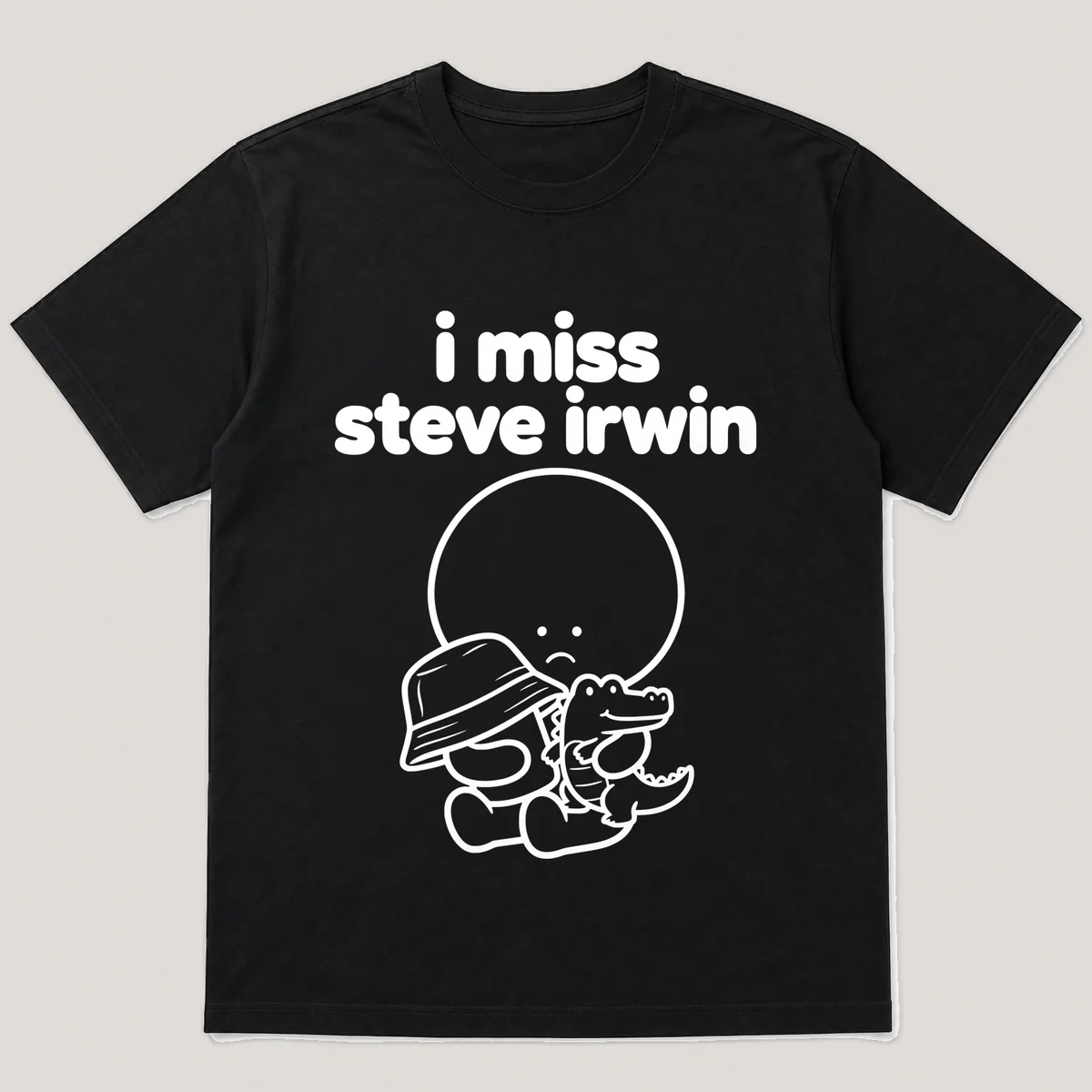 lonely boi tee: a small sad cartoon boy hugging a khaki hat and a small crocodile, with the words i miss steve irwin above him, Black front view
