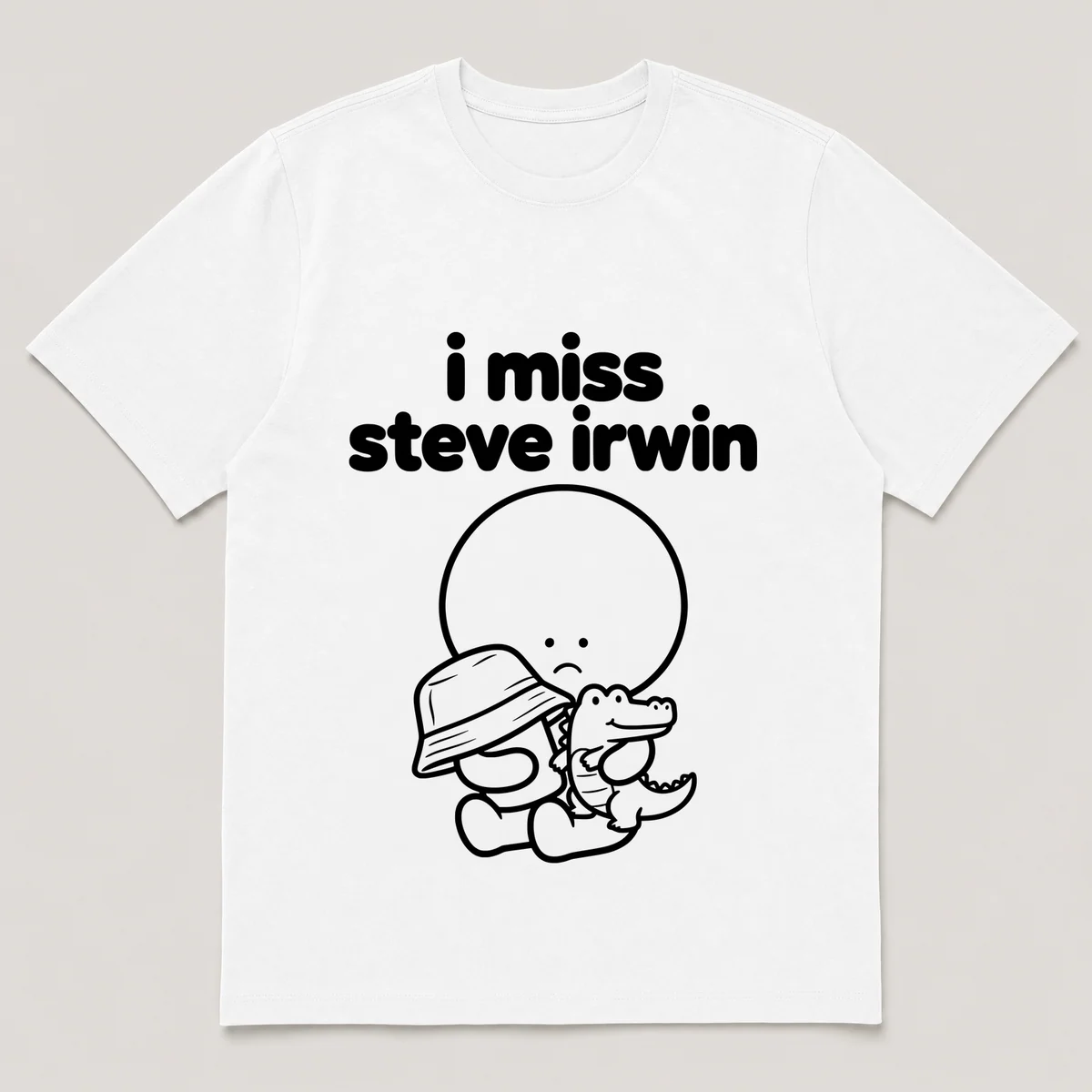 lonely boi tee: a small sad cartoon boy hugging a khaki hat and a small crocodile, with the words i miss steve irwin above him, White front view
