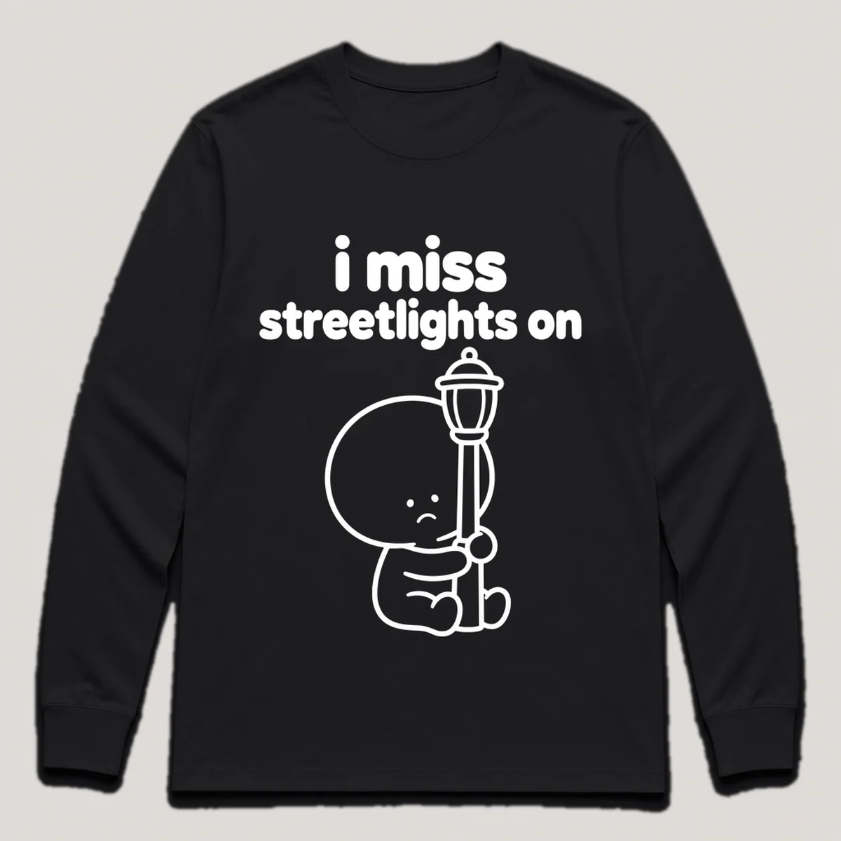 lonely boi tee: a small sad cartoon boy hugging a glowing streetlight at dusk, with the words i miss streetlights on above him, Black front view