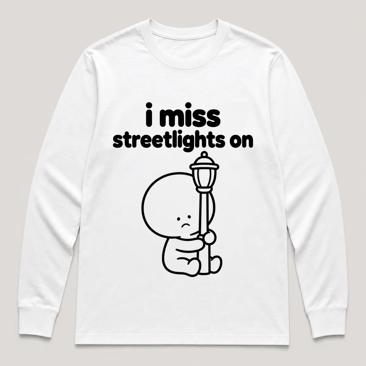 lonely boi tee: a small sad cartoon boy hugging a glowing streetlight at dusk, with the words i miss streetlights on above him, White front view