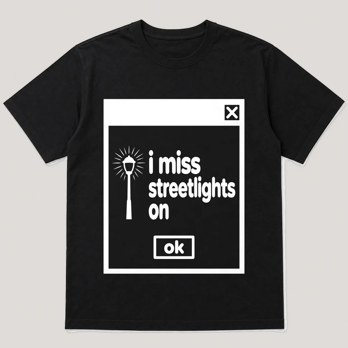lonely boi tee: a retro computer error dialog window with streetlamp glow and the words i miss streetlights on and an ok button, Black front view
