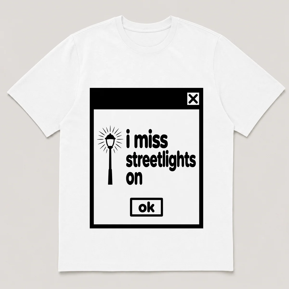 lonely boi tee: a retro computer error dialog window with streetlamp glow and the words i miss streetlights on and an ok button, White front view