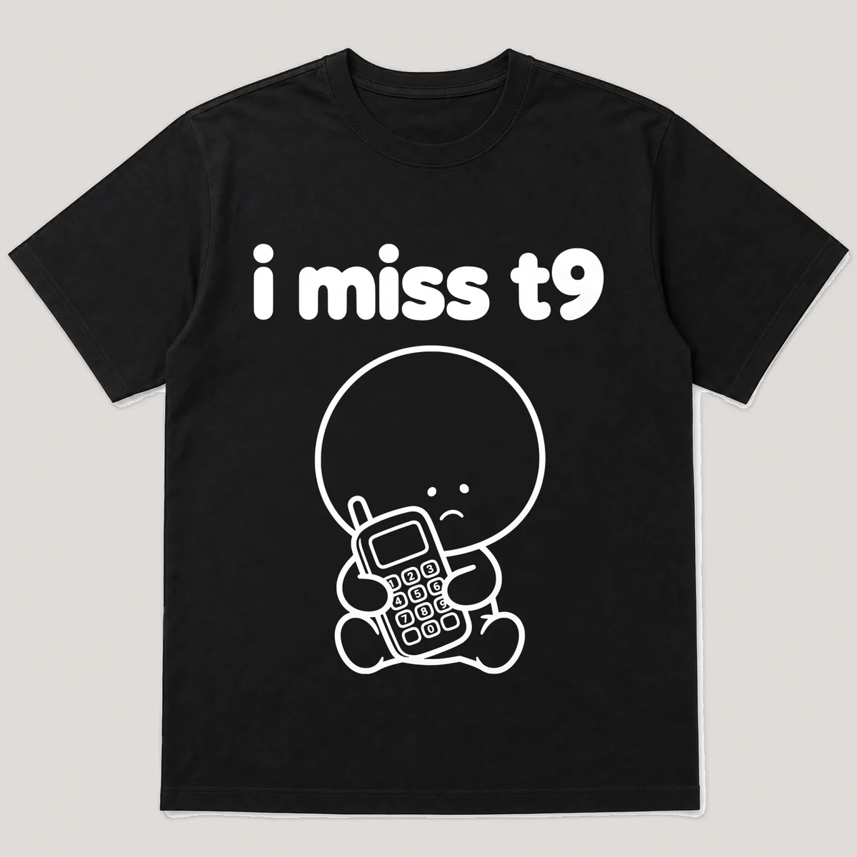 lonely boi tee: a small sad cartoon boy hugging a chunky phone with number keys, with the words i miss t9 above him, Black front view