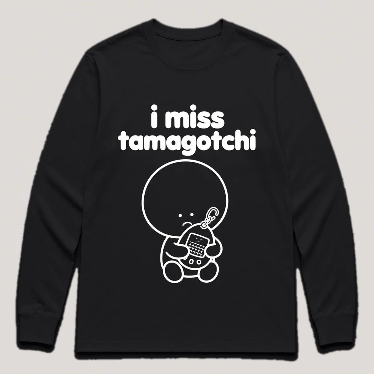lonely boi tee: a small sad cartoon boy hugging an egg-shaped virtual pet keychain, with the words i miss tamagotchi above him, Black front view