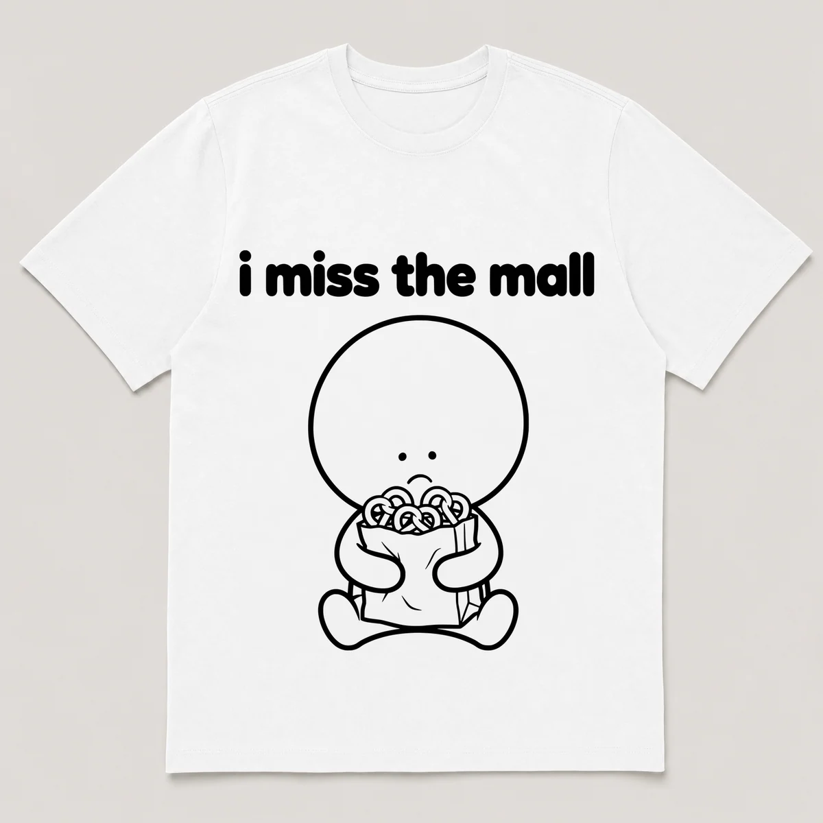 lonely boi tee: a small sad cartoon boy hugging a paper shopping bag with pretzels, with the words i miss the mall above him, White front view