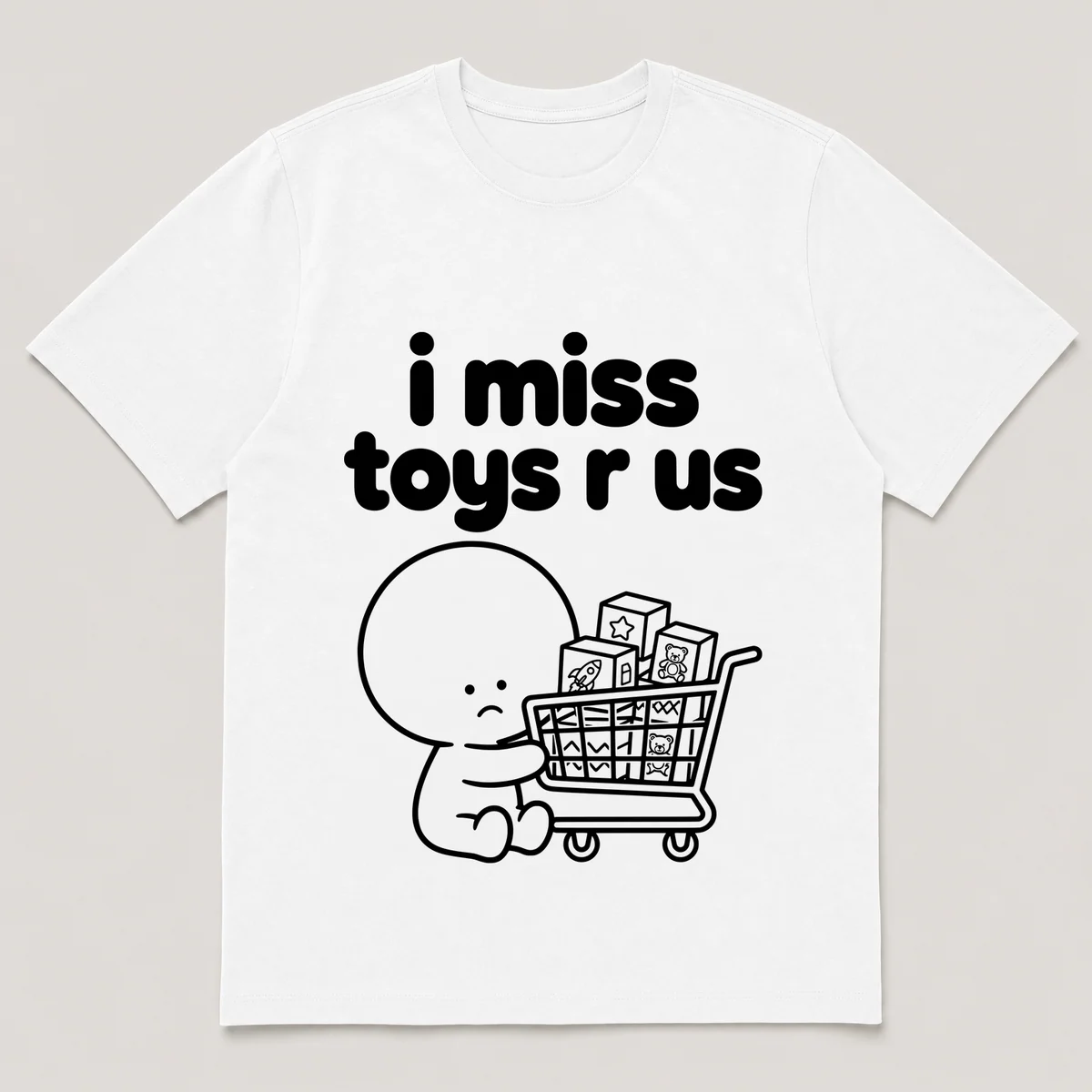 lonely boi tee: a small sad cartoon boy hugging a shopping cart full of toy boxes, with the words i miss toys r us above him, White front view