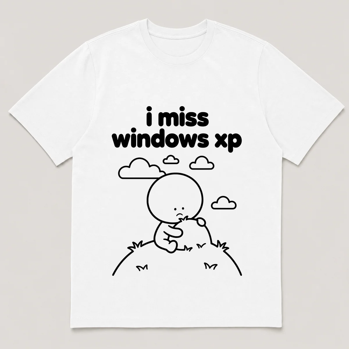 lonely boi tee: a small sad cartoon boy hugging a green hill under a blue sky, with the words i miss windows xp above him, White front view